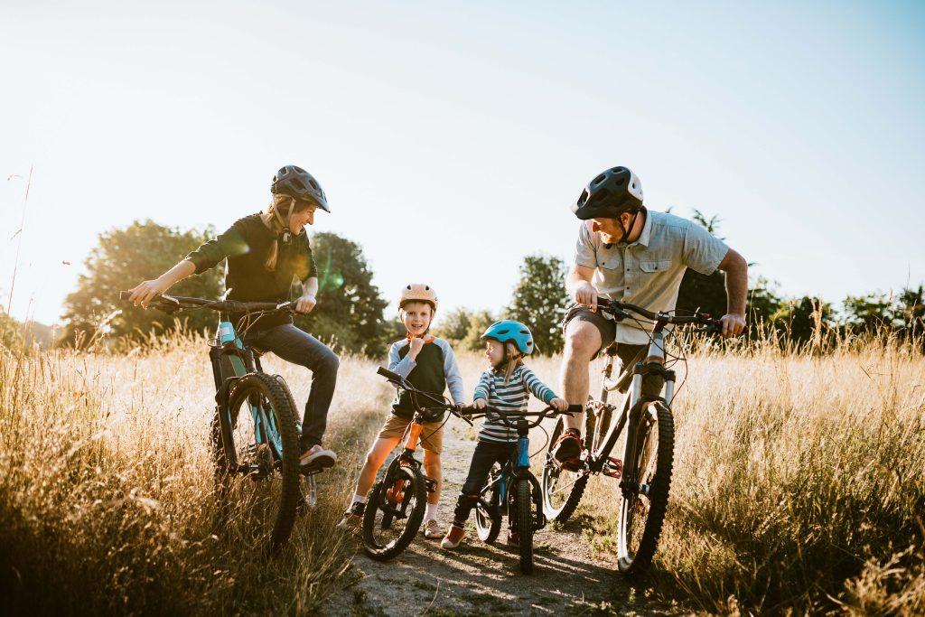 family-mountain-bike-riding-together-on-sunny-day
